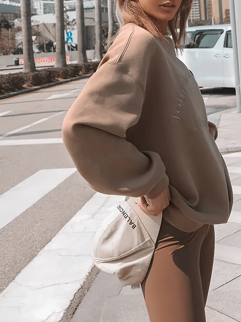 Model wearing Women's Letter Embroidery Solid Color Sweatshirt with brown leggings, styled casually for outdoor fashion.